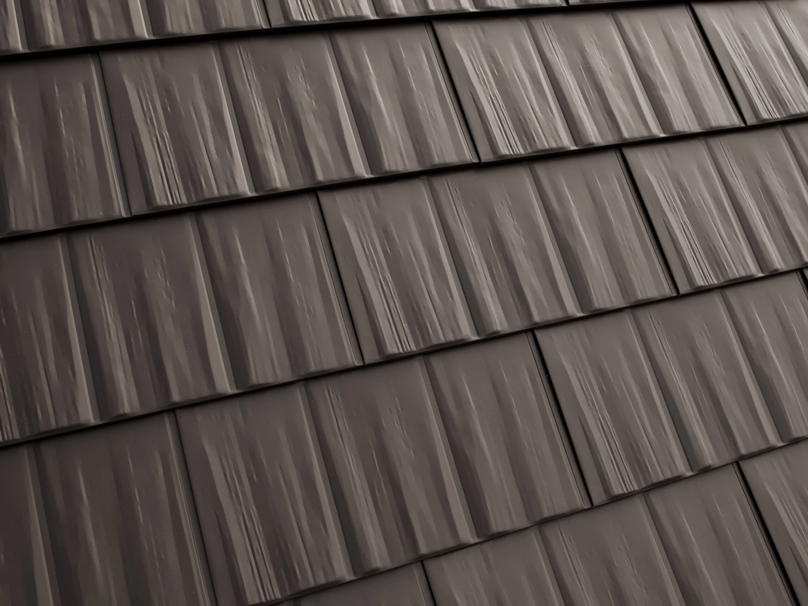 Heavy-gauge aluminum roofing profile resembling cedar shingles, showcasing a textured low-porosity surface designed for durability and reduced maintenance in harsh climates.
