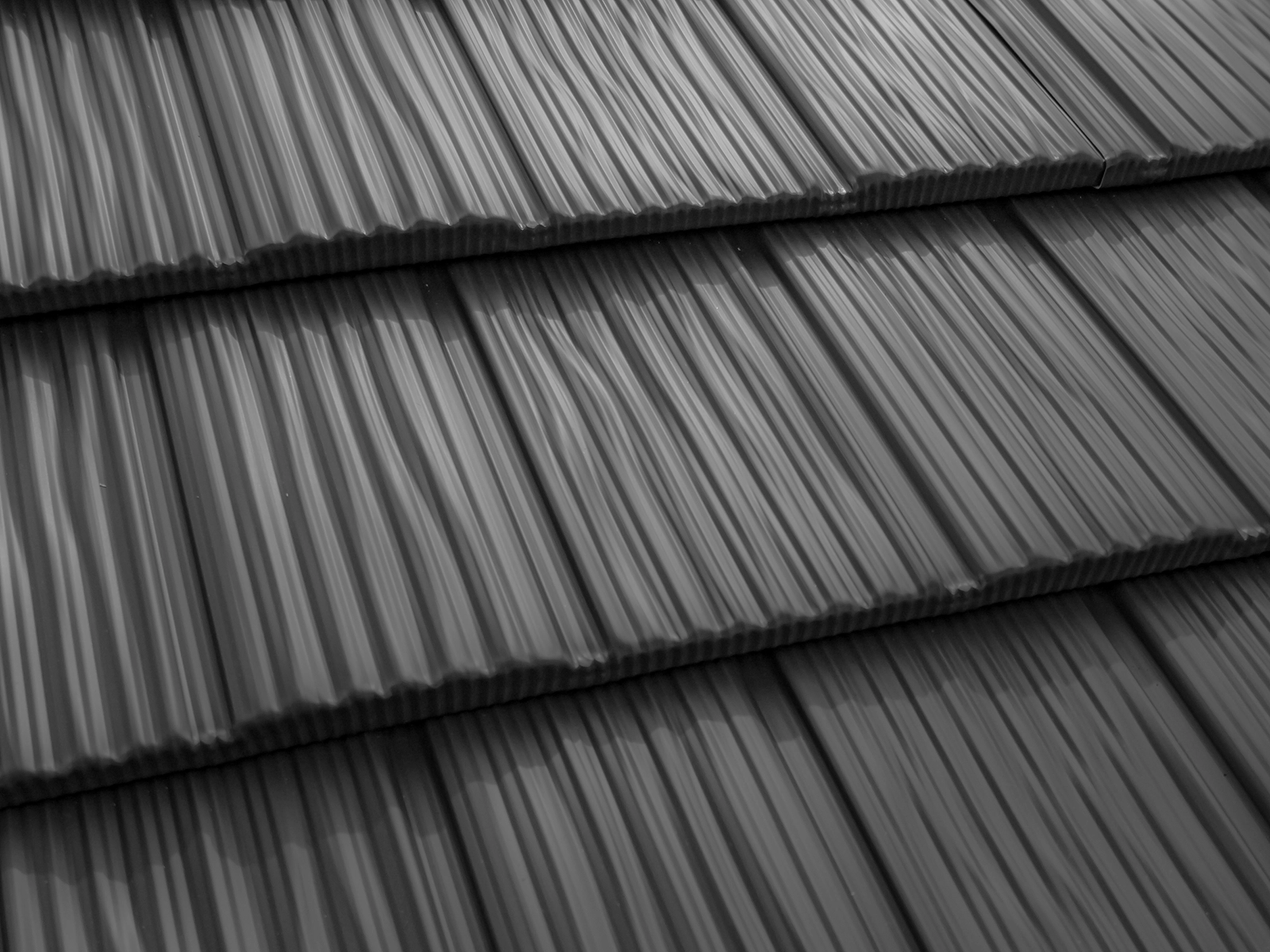 Heavy-gauge aluminum metal roofing profiles showcasing a textured surface, designed for durability and low maintenance, suitable for various styles like Slate and Shake in Burnaby, BC.